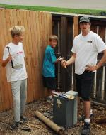 Hammer's in hand, the Pusey boys build a fence.