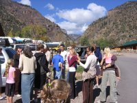 A big clan getting into their BMWs (Big Mormon Wagons)